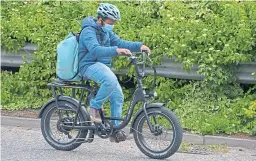  ?? Picture: PA. ?? A delivery rider rides a rentable Bolt e-bike.