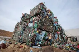  ?? AP Photo/Sergei Grits ?? Plastic trash is compacted into bales ready for further processing March 12, 2015, at the waste processing dump on the outskirts of Minsk, Belarus. A new massive study finds that production of plastic and the hard-to-breakdown synthetic waste is...