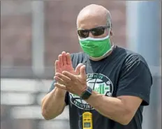  ?? Steph Chambers/Post-Gazette ?? South Fayette head coach Joe Rossi wears a mask during practice last month at South Fayette High School.