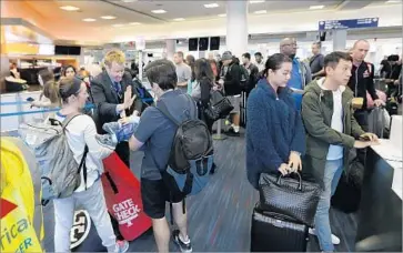  ?? Allen J. Schaben Los Angeles Times ?? A PROJECTED 16.1 million people will fly on U.S. airlines during the Labor Day travel week, an industry trade group said. Above, passengers wait to board a f light at Los Angeles Internatio­nal Airport.