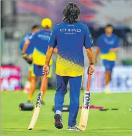  ?? DEEPAK GUPTA/HT ?? Mahendra Singh Dhoni walks with two bats in his hands at the Ekana Stadium in Lucknow on Thursday on the eve of the Chennai Super Kings vs Lucknow Super Giants match.