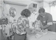  ?? Houston Chronicle file ?? Therapist Scott Farmer and nurse Phyllis Calabrese work with one of the young burn patients at Shriners.