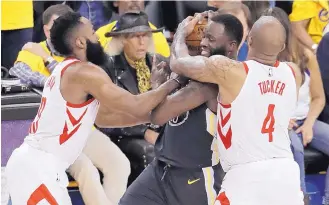  ?? JEFF CHIU/ASSOCIATED PRESS ?? Houston’s P.J. Tucker (4) and James Harden, left, harass Golden State’s Draymond Green in the second half of Tuesday night’s game.