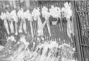  ?? Travis Dove / New York Times ?? Flowers and Ribbons line a makeshift memorial outside Emanuel AME Church in Charleston, S.C.