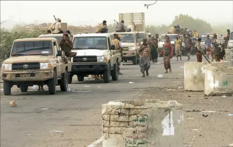  ?? Nabil Hassan/AFP/Getty Images ?? Yemeni pro-government forces arrive in the port city of Hodeida. Backed by a Saudi-led coalition, Yemeni forces launched an offensive to retake the rebel-held city, pressing toward the airport south of town. The port serves as the entry point for 70...