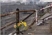  ?? ANTONIO CALANNI — THE ASSOCIATED PRESS ?? A bunch of plastic flowers is seen at the scene of a passenger bus accident in Mestre, near the city of Venice, Italy, Wednesday. The bus fell from an elevated road late Tuesday, killing multiple people.