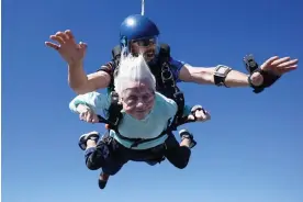  ?? Ottawa, Illinois. Photograph: Daniel Wilsey/AP ?? Hoffner with tandem jumper Derek Baxter on 1 October 2023 at Skydive Chicago in