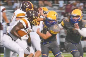  ?? The Sentinel-Record/Grace Brown ?? MAKING THE STOP: Lakeside junior Caleb Weed (65) and senior Will Perrigo (24) move in to stop Lake Hamilton sophomore running back Kendrick Martin (4) during an Aug. 28 game at Chick Austin Field. The Rams host Camden Fairview tonight.