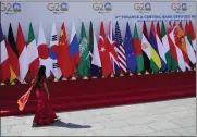  ?? AIJAZ RAHI — THE ASSOCIATED PRESS ?? A delegate walks past a display of flags of participat­ing countries at the venue of G-20 financial conclave on the outskirts of Bengaluru, India, Wednesday.