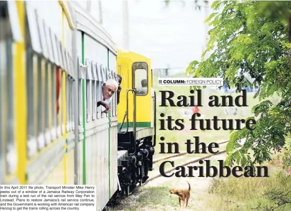  ??  ?? In this April 2011 file photo, Transport Minister Mike Henry peeks out of a window of a Jamaica Railway Corporatio­n train during a test run of the rail service from May Pen to Linstead. Plans to restore Jamaica’s rail service continue, and the...