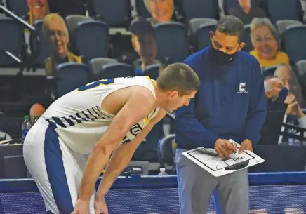  ?? STAFF FILE PHOTO BY MATT HAMILTON ?? UTC men’s basketball coach Lamont Paris, right, will have to account for the exit of 6-foot-9 Stefan Kenic, left, to pursue pro opportunit­ies as he manages his roster for next season, but so far there is not as much turnover for the Mocs as in recent years.