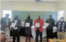  ?? SUPPLIED Picture: ?? WELCOME RELIEF: School principals receive face masks donations from the Mkiva Humanitari­an Foundation in Dutywa.