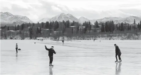  ??  ?? Ice skaters take advantage of unseasonab­le warm temperatur­es outside at Westcheste­r Lagoon in Anchorage, Alaska.