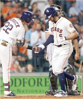  ?? BOB LEVEY/GETTY IMAGES ?? The Astros’ Josh Reddick congratula­tes Jake Marisnick on his solo homer in the third inning Monday night against the White Sox, who were held to six hits in a 3-0 loss.