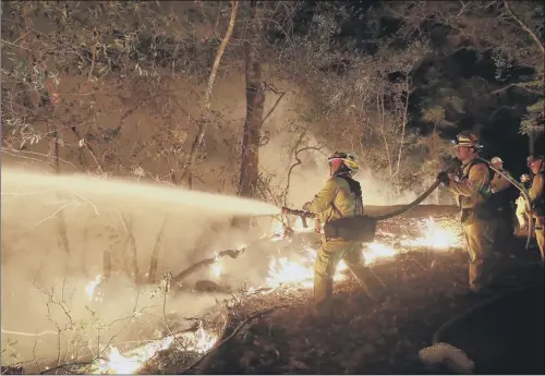  ??  ?? Fire crews battle a wildfire in Santa Rosa, California.