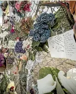  ?? ROSA WOODS/STUFF ?? Memorials to those killed and injured were left on the Whakatane waterfront.