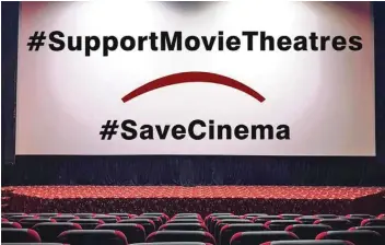  ??  ?? A placard to save movie theatres.