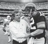  ?? Bill Lyons Associated Press ?? ‘A COLORFUL HEAD COACH’ Patriots coach Ron Meyer congratula­tes Steelers quarterbac­k Terry Bradshaw in 1982.