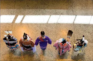  ?? Herald photo by Ian Martens ?? Dancers stand in a row for judging after performing in the women’s traditiona­l portion during a powwow as part of Native Awareness Week Monday in the atrium at the University of Lethbridge. @IMartensHe­rald