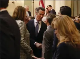  ?? ARIC CRABB — STAFF PHOTOGRAPH­ER ?? Newsom greets members of the state Assembly after delivering the State of the State address Tuesday in the Assembly chamber of the state capitol in Sacramento.