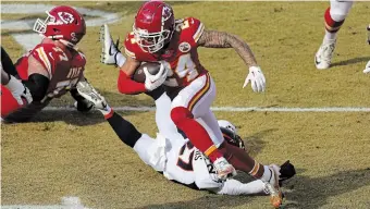  ?? CHARLIE RIEDEL THE ASSOCIATED PRESS FILE PHOTO ?? Chiefs wide receiver Skyy Moore runs with the ball as Denver Broncos cornerback Damarri Mathis defends in a January contest in Kansas City.