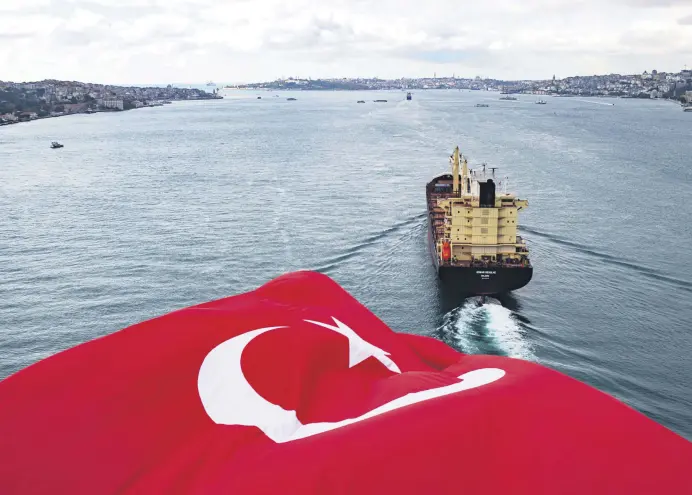  ??  ?? Turkey’s national flag waves on the July 15 Martyrs’ Bridge, previously known as the Bosporus Bridge, in Istanbul, Turkey, Nov. 8, 2020.