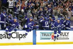  ?? AP Photo/Chris O’Mear ?? Tampa Bay Lightning players celebrate after defeating the New York Islanders in Game 7 of an NHL hockey Stanley Cup semifinal playoff series Friday in Tampa, Fla.