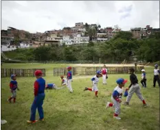  ?? ARIANA CUBILLOS — THE ASSOCIATED PRESS ?? Young players run laps during a practice at Las Brisas de Petare Sports Center, in Caracas, Venezuela.