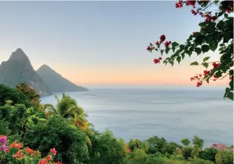  ??  ?? Captivatin­g Caribbean: St Lucia’s dramatic Pitons, above; Barbados carnival spirit, right; pristine beaches await on St Barts, far right