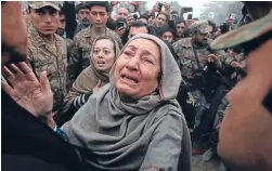  ?? Photo: REUTERS ?? Grief-stricken: Grandmothe­r, right, and mother of Muhammad Ali Khan, a student who was killed during an attack by Taliban gunmen on Army Public School, react during a visit by Imran Khan, left, chairman of Pakistan Tehrik-e-Insaf political party, at...