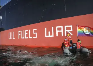  ?? ?? Greenpeace activists confront a shipment of Russian oil in Denmark. Kristian Buus/Greenpeace