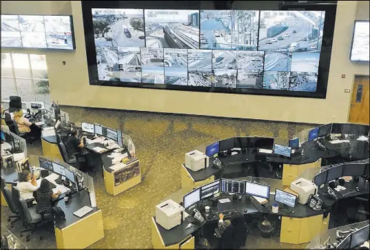  ?? Rio Lacanlale Las Vegas Review-Journal ?? Workers monitor traffic Friday across the Las Vegas Valley at the Nevada Highway Patrol’s southern command.