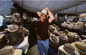  ?? Paul Kuroda / Special to The Chronicle ?? Mario Barajas, above, at his hat stand at the Antioch Flea Market, right, a popular spot for window-shopping and grabbing a variety of food and drink.