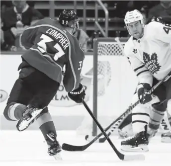  ?? David Zalubowski, The Associated Press ?? Avalanche forward J.T. Compher scores the power-play goal that beat the Toronto Maple Leafs 4-3 in overtime Friday night at the Pepsi Center.