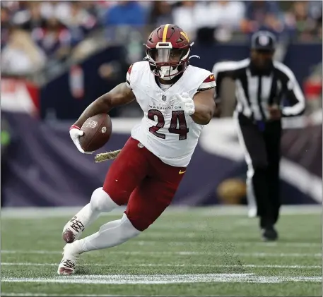  ?? MICHAEL DWYER — THE ASSOCIATED PRESS ?? Washington Commanders running back Antonio Gibson carries the ball in the first half of an NFL game against the New England Patriots on Sunday, Nov. 5, 2023 in Foxboro.