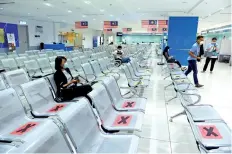  ?? — Bernama photo ?? Photo shows people practising social distancing at the Immigratio­n Department as part of the CMCO SOP set by the Health Department.