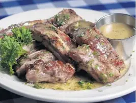  ?? SUSAN STOCKER/SOUTH FLORIDA SUN SENTINEL ?? Greek Islands Taverna’s baby back ribs with ladoregano sauce.