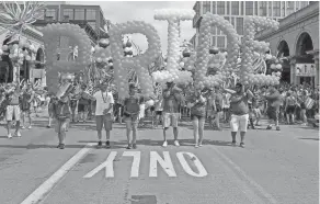  ?? BROOKE LAVALLEY/THE COLUMBUS DISPATCH ?? Parade participan­ts carry balloons during the 2017 Stonewall Columbus Pride Festival and March. This year's Pride celebratio­n will take place June 16-17.