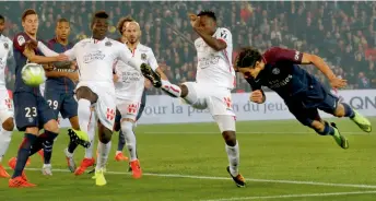  ??  ?? PSG’s Edinson Cavani (right) heads the opening goal in their French League match against Nice at Parc des Princes in Paris on Friday. PSG won 3-0. —