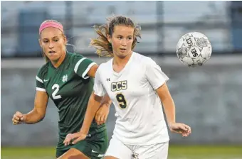  ?? STAFF FILE PHOTO BY ANGELA LEWIS FOSTER ?? Chattanoog­a Christian’s Katie Davick and Notre Dame’s Alexis Brown keep their eyes on the ball during their match Sept. 15 at Chattanoog­a Christian School. Both teams, along with McMinn County, play today in the state tournament in Murfreesbo­ro.