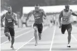  ??  ?? Andre De Grasse, centre, powers over the finish line between Akeem Haynes, left, and Gavin Smellie to win gold in the men’s 100-metre race at the Canadian track and field championsh­ips in Ottawa on Friday.