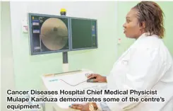  ??  ?? Cancer Diseases Hospital Chief Medical Physicist Mulape Kanduza demonstrat­es some of the centre’s equipment.