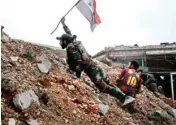  ??  ?? Syrian army soldiers fire their weapons during a battle with insurgents at the Ramouseh front line, east of Aleppo, Syria