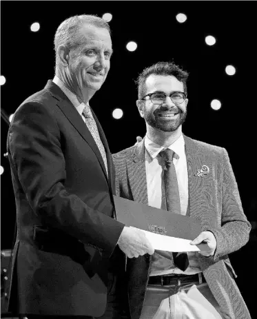  ?? LARRY WONG/ EDMONTON JOURNAL ?? Omar Mouallem, right, writer-in-residence at the Edmonton Public Library, receives the Northlands Award for an emerging artist from Northlands president and CEO Richard Andersen at the 26th Annual Mayor’s Celebratio­n of the Arts Awards on Monday at the...