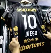  ??  ?? Dorados football team jerseys bearing the number 10 and the name of Diego Maradona are on display. — AFP