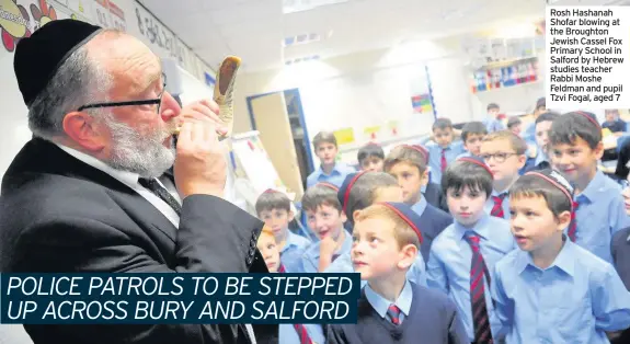  ??  ?? Rosh Hashanah Shofar blowing at the Broughton Jewish Cassel Fox Primary School in Salford by Hebrew studies teacher Rabbi Moshe Feldman and pupil Tzvi Fogal, aged 7