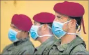  ?? AFP ?? Spanish soldiers wearing face masks stand outside a sports centre n converted into a temporary shelter for the homeless in Valencia.