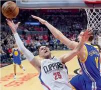  ?? AP ?? Clippers Austin Rivers shoots as Warriors Thompson defends. —