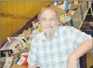  ?? (NWA Democrat-Gazette/Rachel Dickerson) ?? Paul Poulides, president of the board of directors of the Bella Vista Recycling Center, is pictured next to a conveyor belt filled with cardboard at the center. He volunteers at the center regularly.