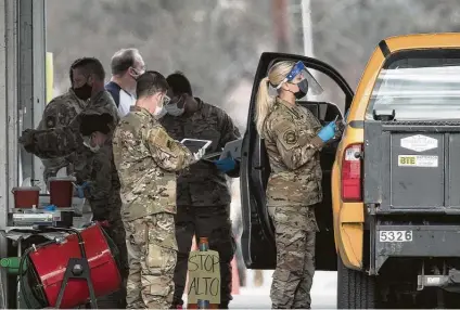  ?? Photos by Brett Coomer / Staff photograph­er ?? Military personnel give COVID-19 vaccine shots Wednesday at the newly opened FEMA supersite at NRG Park.